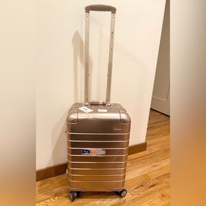 Away Aluminum Carry-On suitcase in the rose gold